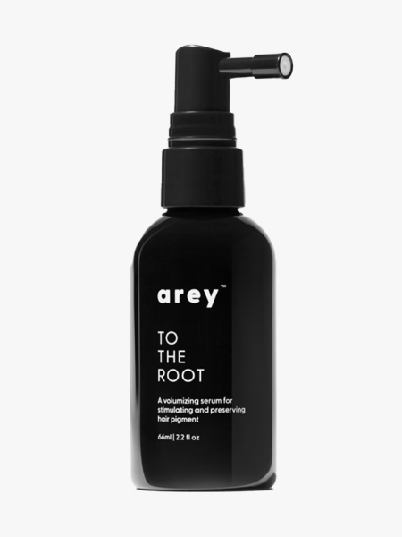 Arey To The Root Serum black bottle on light gray background